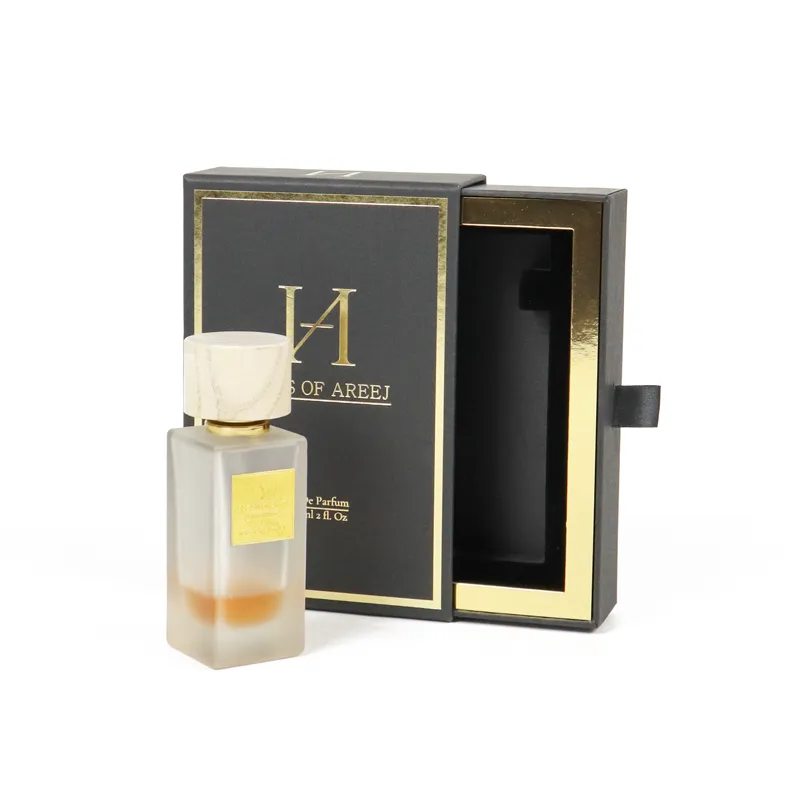 Three-quarter angled shot of open gold-lined slide drawer perfume boxes with matching frosted perfume bottle seated inside EVA insert