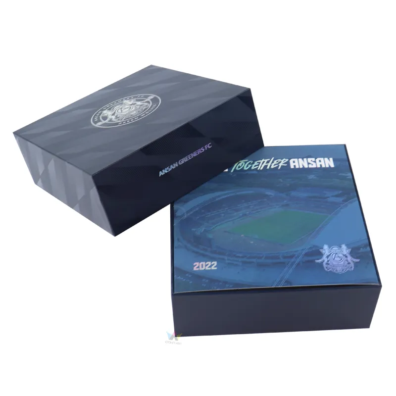 Three quarter standing display of dark geometric patterned essential oil gift boxes with printed club brand text on side panel