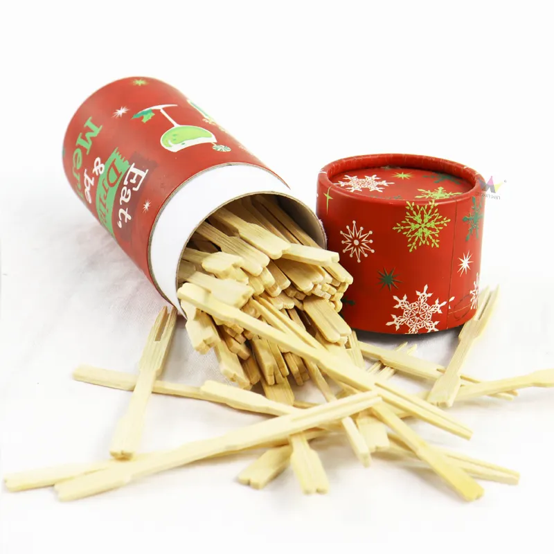 Tilted holiday cylinder box spilling natural bamboo skewers, custom printed paper tube packaging