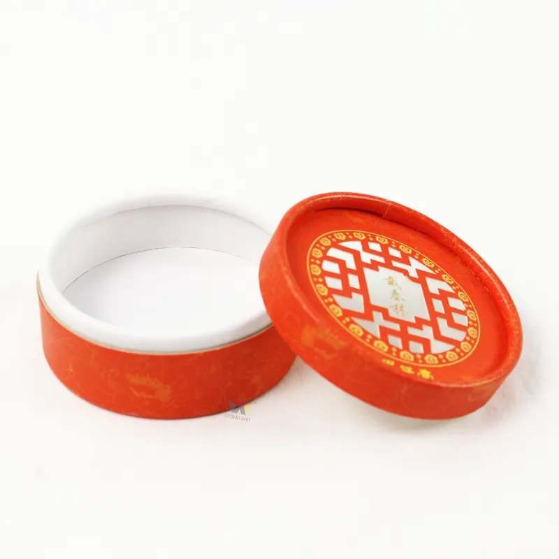 Slanted view of short cylinder boxes with lifted separate round lid, eco-friendly paper tube packaging