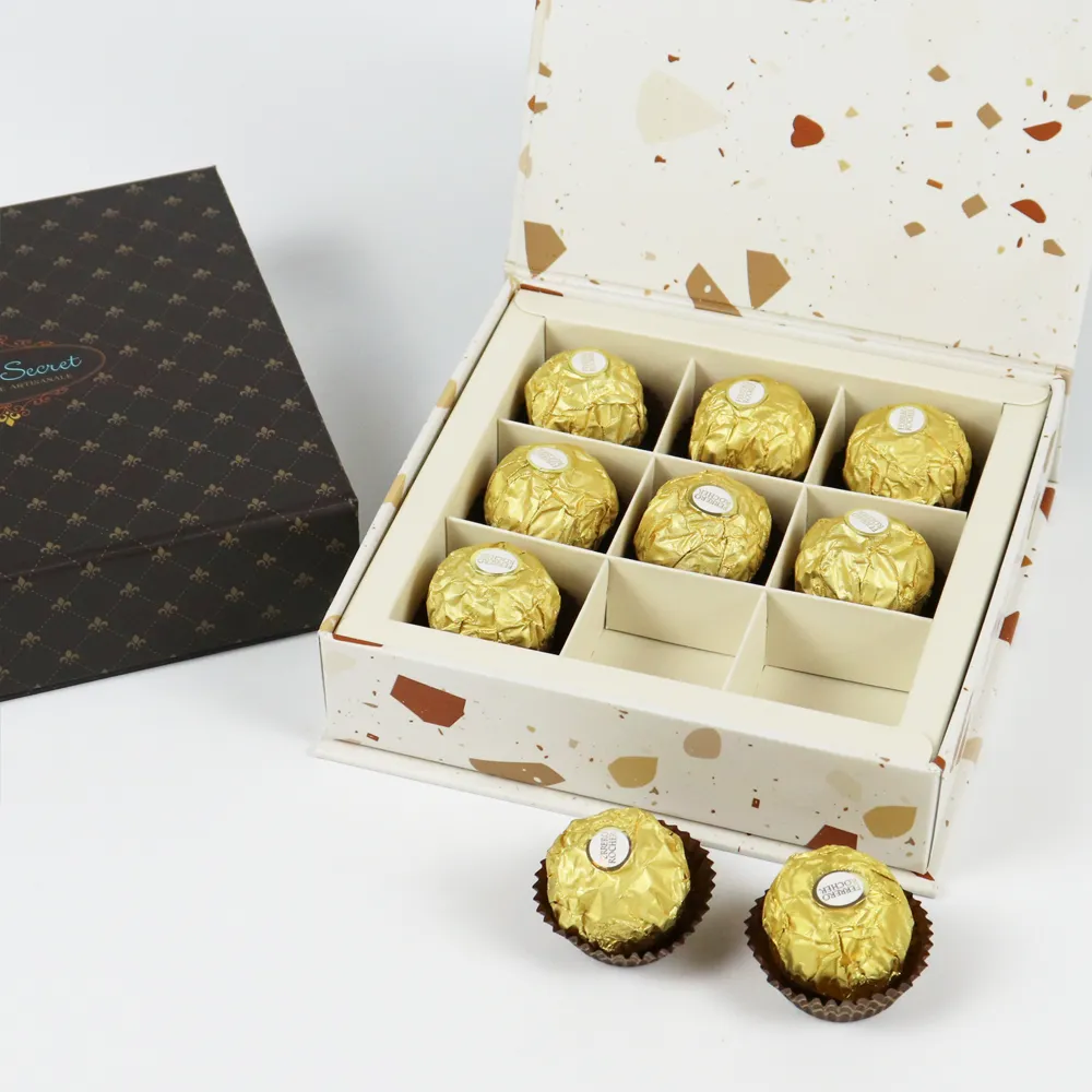 Top overhead view fully open flip lid magnetic box with complete 9-hole grid divider filled with round gold foil chocolate truffles