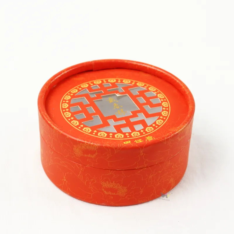 Top overhead view of red cylinder boxes with traditional hollow window cutout on round lid