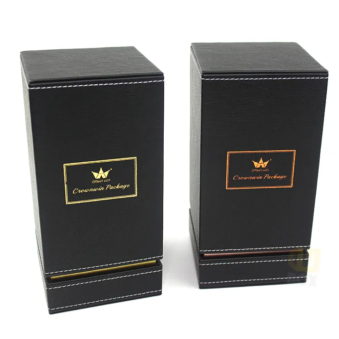 Two sizes of tall black PU leather stitched candle boxes side by side, one with gold foil logo, one with copper hot foil framed brand emblem