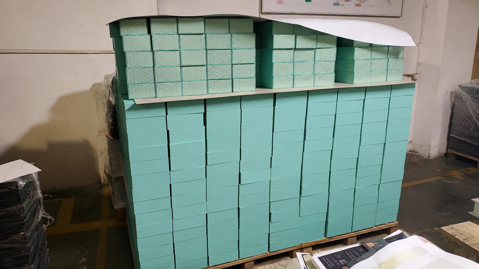 Mass production stacked custom printed cosmetic rigid boxes in Crown Win Packaging factory warehouse for skincare brands