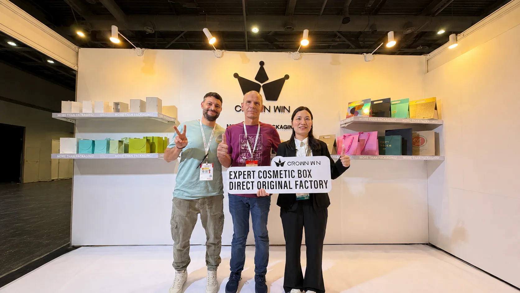 Group photo of Crown Win sales team and overseas buyers at Hong Kong packaging fair booth with custom cosmetic box sign