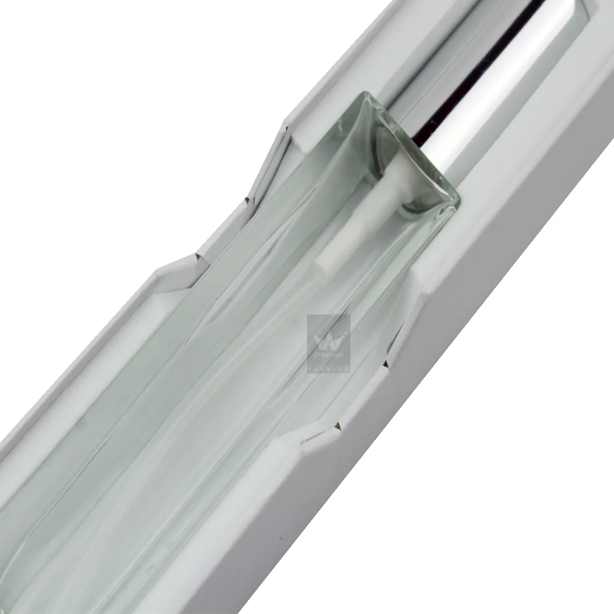 Close‑up view of custom die‑cut paper insert holding slim essence spray bottle inside sliding drawer skincare packaging