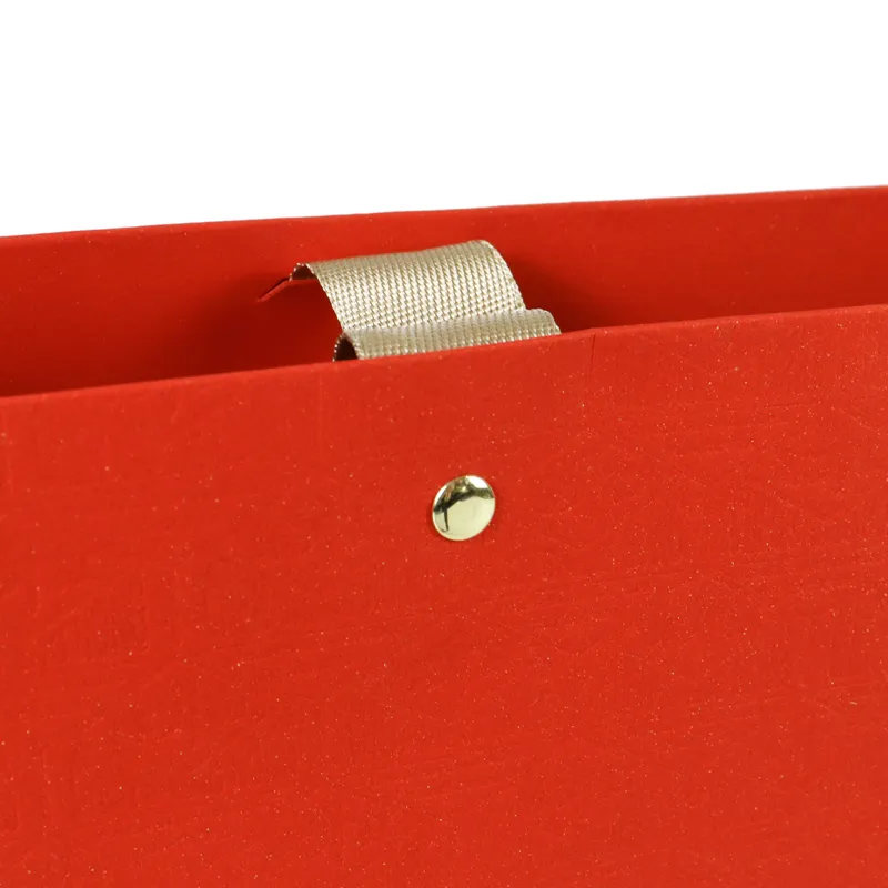 Tea packaging paper bag metal rivet and satin ribbon handle close‑up detail