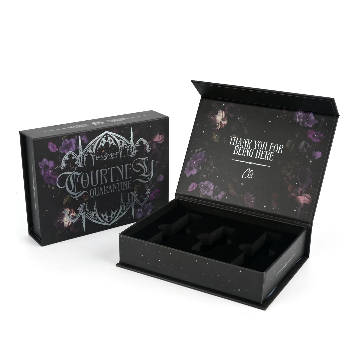 Open black cosmetic gift box with a floral printed lid and fitted compartments
