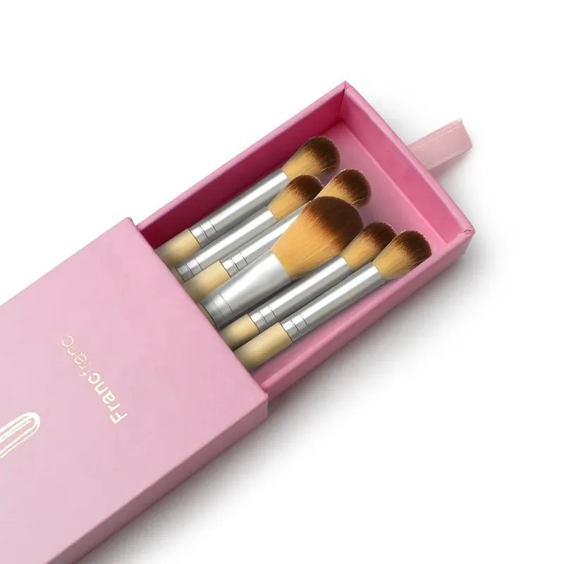 Pink drawer box displaying a coordinated set of makeup brushes
